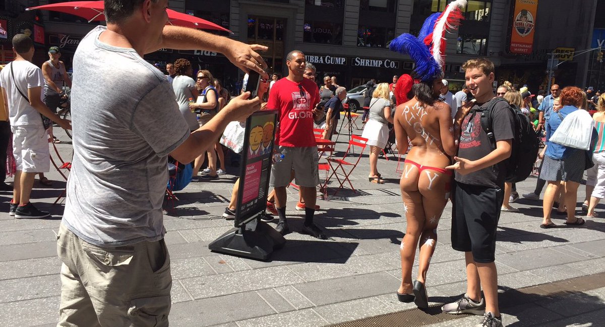 NYPD cops take photos with topless Times Square women - NY 