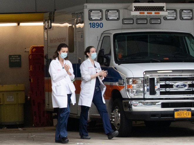 Medical personel rub their hands as they leave the emergency room at NewYork-Presbyterian Lower Manhattan Hospital last week.