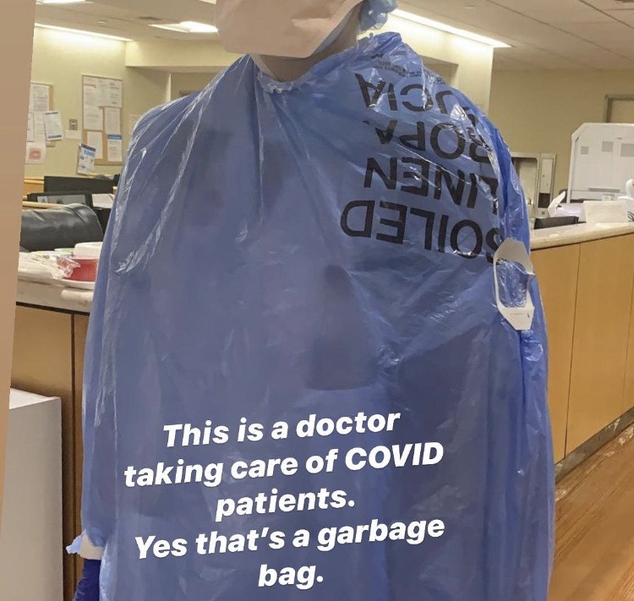 A photo showing a health care worker using a garbage bag as Personal Protective equipment at a prominent NYC emergency room during the COVID-19 pandemic.