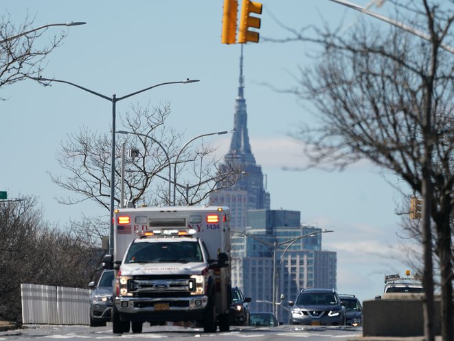 The Empire State Building rises over an FDNY Ambulance on Queens Blvd. in the Borough of Queens in New York, New York, USA, 24 March 2020