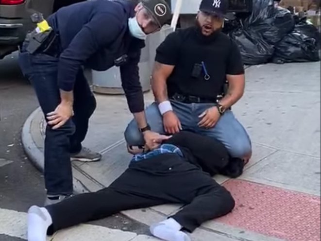 Francisco Garcia, seen in the black t-shirt and Yankees cap, kneels on a man's head after punching him during social distancing enforcement in the East Village COURTESY OF WITNESS DAQUAN OWENS
