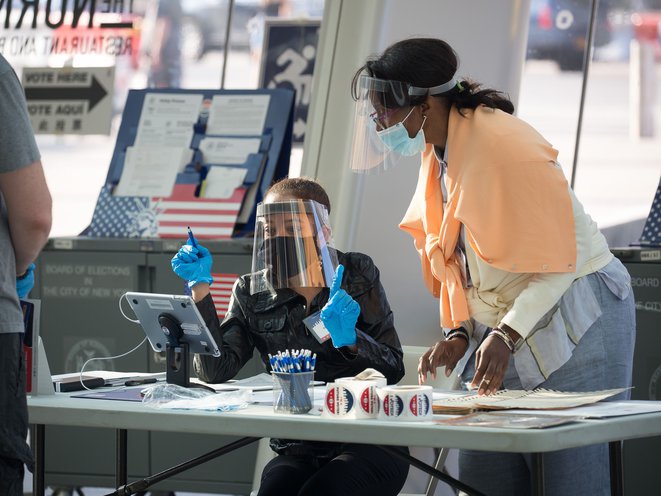 Poll workers wearing personal protective equipment work at a polling site in Brooklyn, June 23, 2020. CHINE NOUVELLE/SIPA/SHUTTERSTOCK