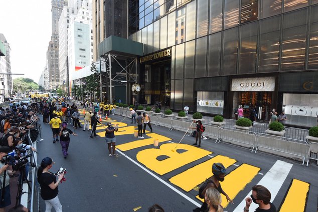 A photo of people painting Black Lives Matter in front of Trump Tower on June 9th, 2020