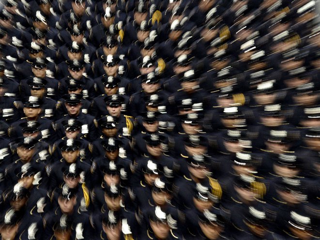 A zoom effect shows an aerial shot of officers in their dress uniforms.