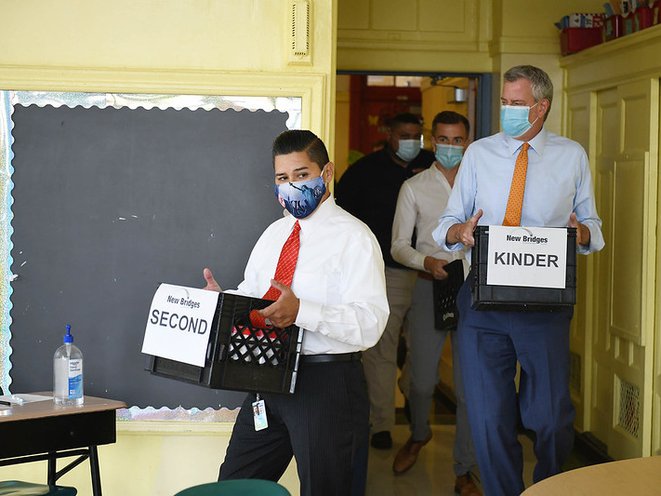 Mayor Bill de Blasio (right) and Schools Chancellor Richard Carranza (center) tour New Bridges Elementary in August to observe the school’s PPE delivery and reopening preparations.
