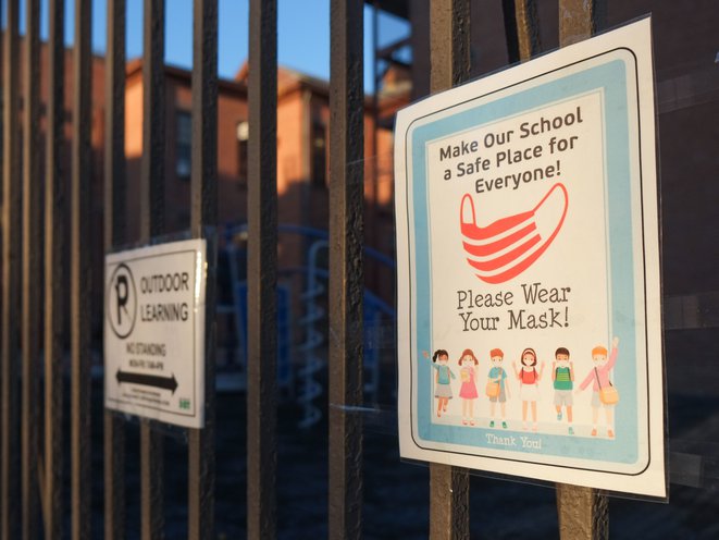 A sign posted outside a school in Brooklyn reads, "Make Our School A Safe Place For Everyone".
