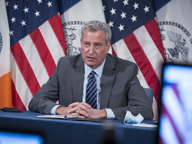 MAyor Bill de Blasio in a grey suit and striped tie addressed the public during a daily press briefing
