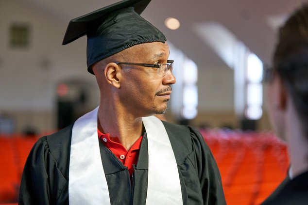 Sheldon Johnson wearing a cap and gown at a graduation ceremony.
