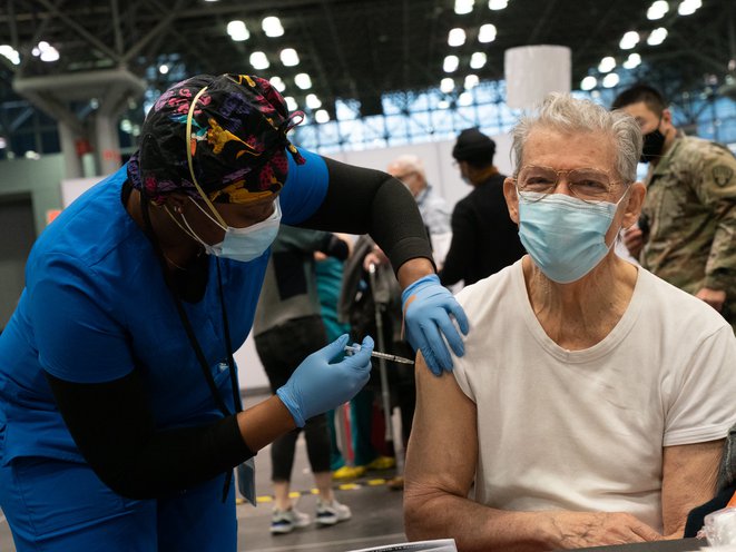 An unidentified man receives a COVID-19 immunization on opening day of the large-scale vaccination site at the The Javits Center