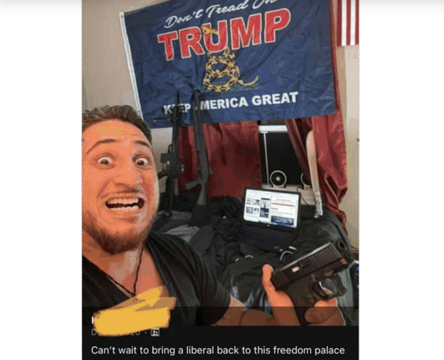An image of Fisher holding a gun in front of a Trump flag that he allegedly posted to Facebook