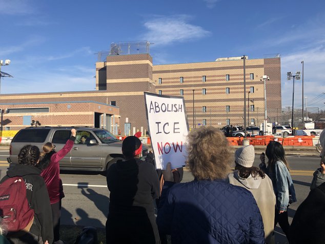 Protesters hold signs asking that prisoners be released