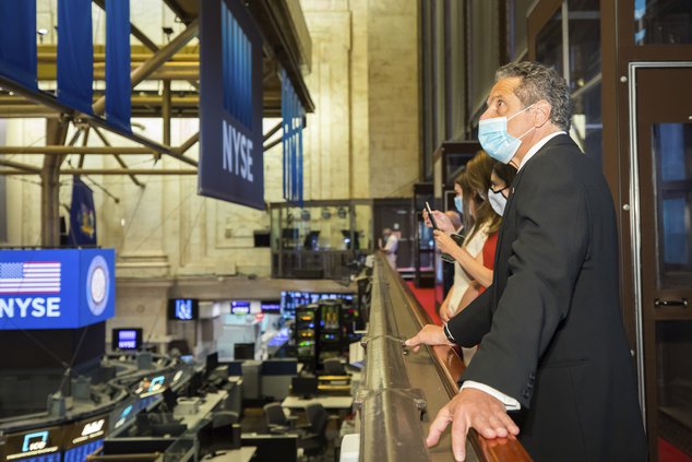 New York State Governor Andrew Cuomo wears a mask and rings the opening bell New York Stock Exchange President Stacey Cunningham to mark the historic reopening of the NYSE Trading Floor on May 26, 2020.