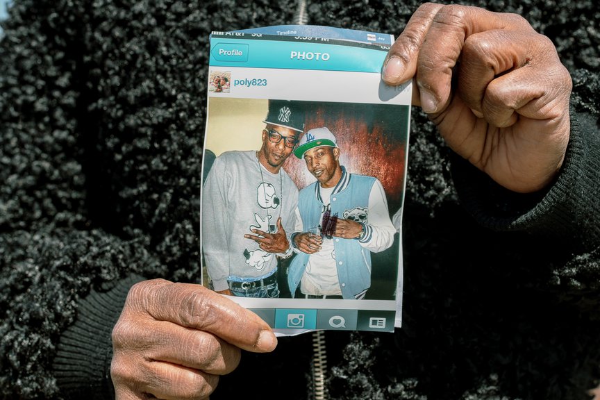 The mother of Roberto Grant, Crecita Williams, holds a photo of Grant with his younger brother.