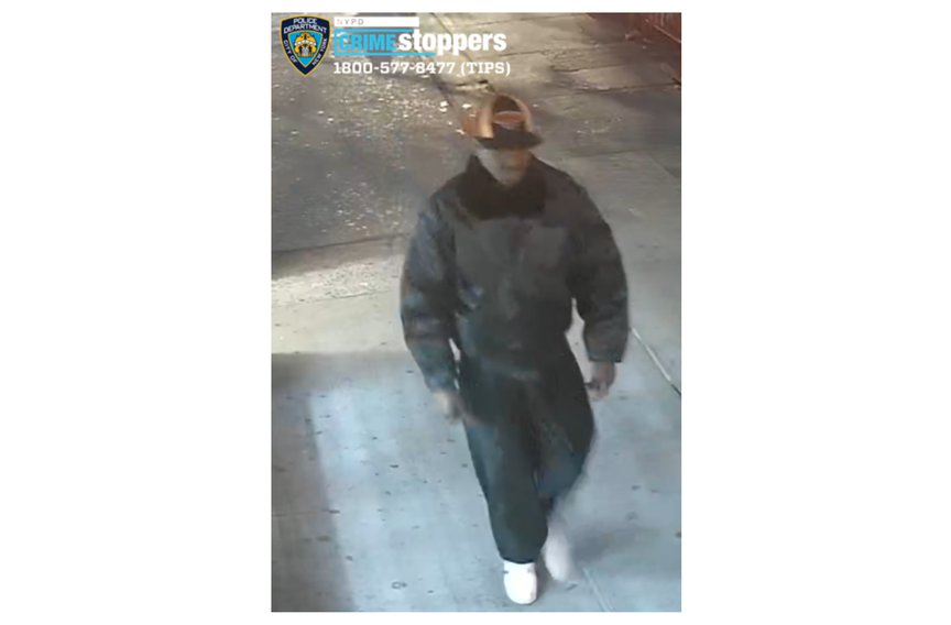 The suspect walking on the sidewalk in a photograph released by the NYPD.