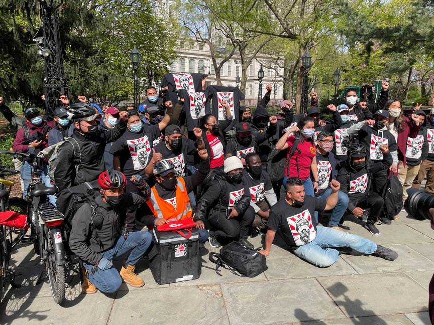 Dozens of delivery workers who are members of the collective Los Deliveristas Unidos outside City Hall on Tuesday afternoon after a press conference announcing the new legislation.