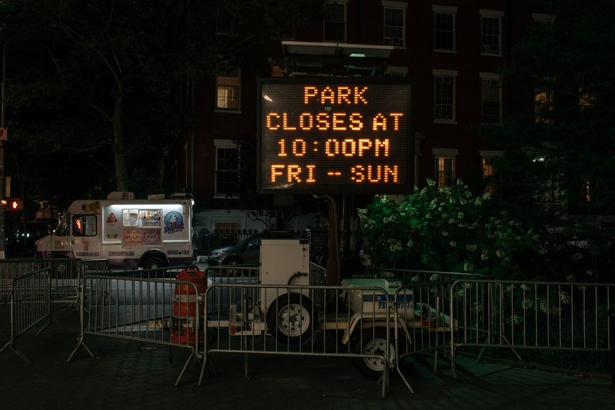 A sign inside Washington Square Park indicating the new curfew