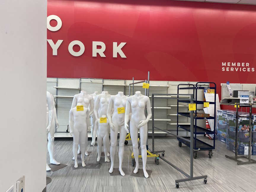 Mannequins and empty clothing racks inside Kmart