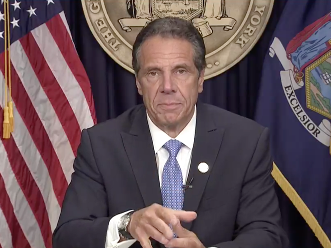 Governor Cuomo in front of the state seal