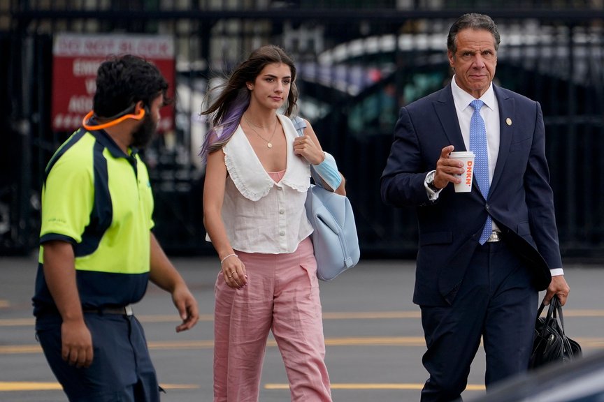 Governor Andrew Cuomo, holding a coffee, walks outside to an awaiting helicopter with daughter Michaela Kennedy Cuomo by his side