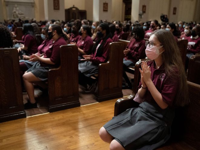 Applause is given during a reception for Bishop Robert Brennan by students and faculty from St. Saviour Catholic Academy and St. Saviour High School in Brooklyn, September 29th, 2021