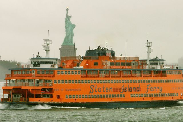 A Staten Island ferry passes the Statue of Liberty.