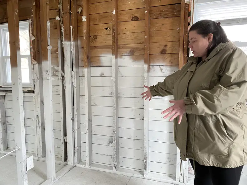 Maryann Morris walks through her gutted single-story home in the Lost Valley section of Manville on Wednesday, March 23, 2022. Her home was damaged months earlier by the remnants of Hurricane Ida.