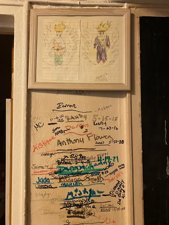 A wall in Bridget Smith's Flatbush apartment displays multiple lines and names, showing the varying heights of her family.