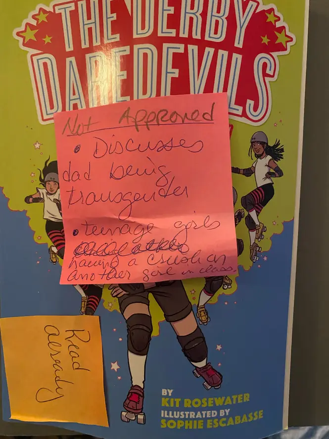 A "Derby Daredevils" book with a sticky note reading "Not approved. Discusses being transgender. Teenage girls having a crush on another girl in class."